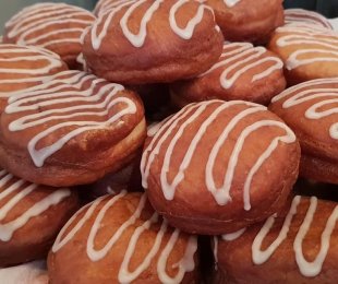 Zdjęcie przedstawia pączki z wegańską nutellą polane lukrem